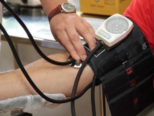 A nurse checking blood pressure