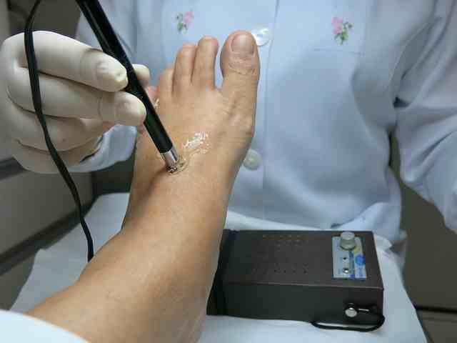 A podiatrist examines a patient's foot